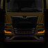 Frontansicht eines goldenen MAN TGX Lastwagens mit leuchtenden, bernsteinfarbenen Tagfahrlichtern.