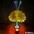 Gelbe Deko-Sonnenblumen mit wei�er LED-Beleuchtung und rotem Sockel.