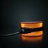 Strands Spiegelleuchte FOR9T: orange leuchtende, runde Leuchte mit schwarzem Geh�use und Kabel.